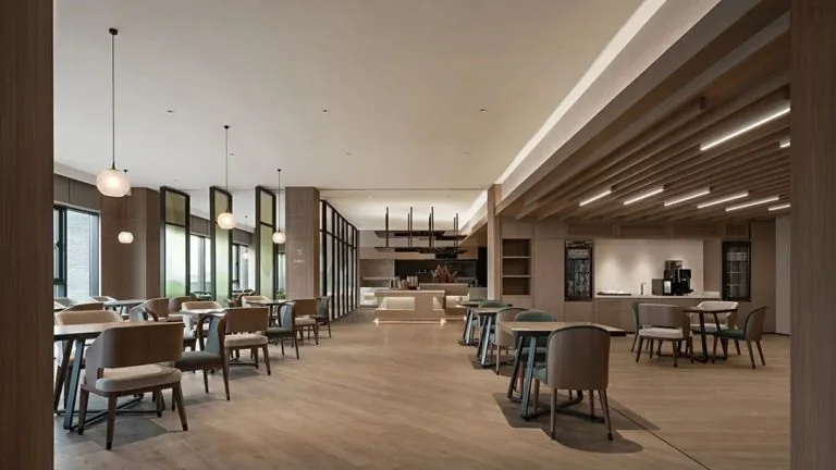 GEORGE Group hotel dining room with loose tables, upholstered chairs and a beverage counter