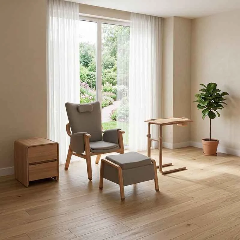 Patient-room companion furniture scene with upright chair, ottoman, bedside cabinet and loose table