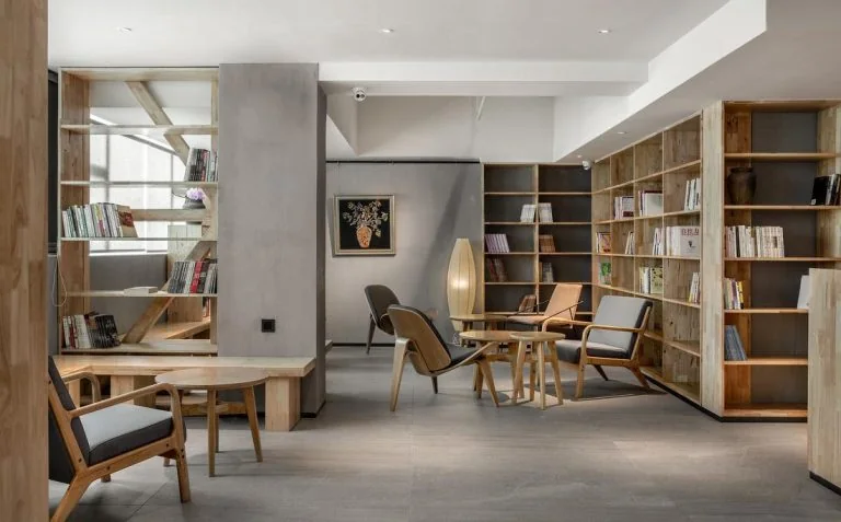 GEORGE Group project image with a round meeting table, chairs, shelving and an adjacent lounge setting